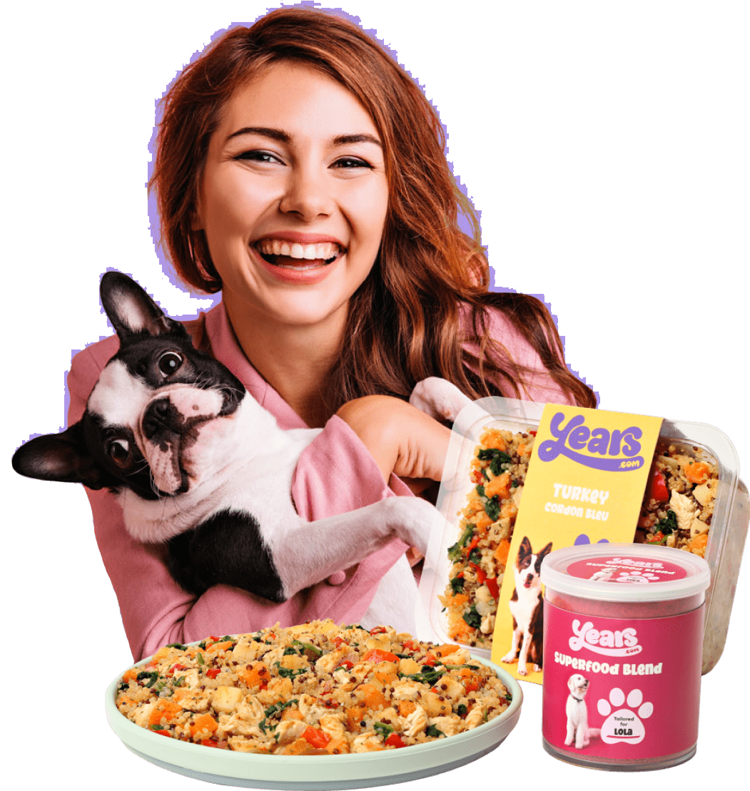 smiling girl with dog and years meal
